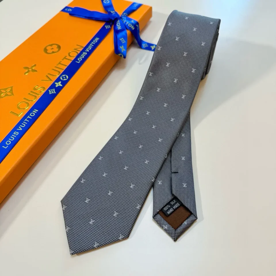 Louis Vuitton tie gray silk fabric with subtle LV monogram pattern and branded box packaging
