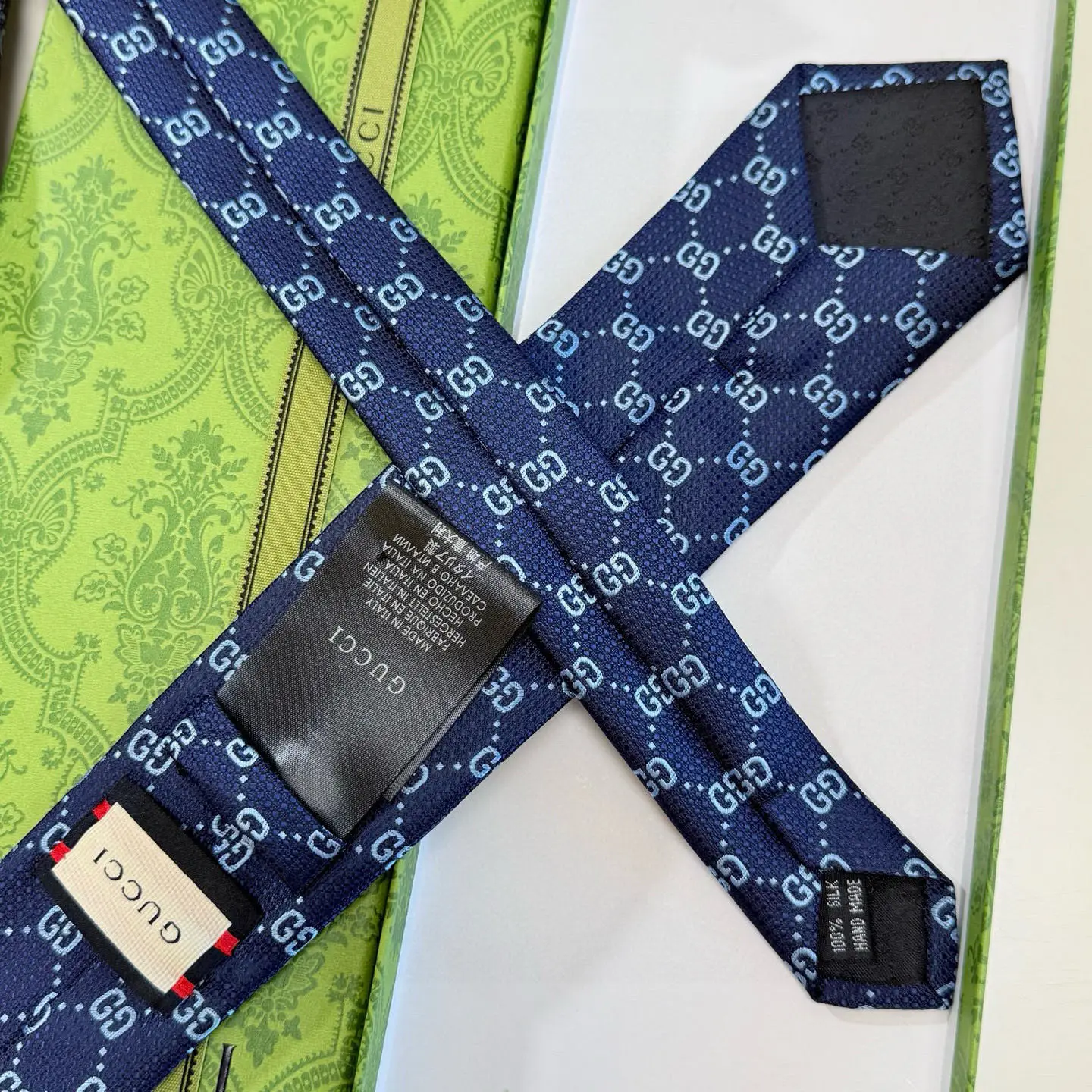 Gucci tie blue silk patterned accessory with iconic GG logo design and fine fabric craftsmanship