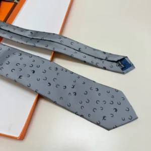 Hermès tie gray silk necktie with black horseshoe pattern and blue label detailing
