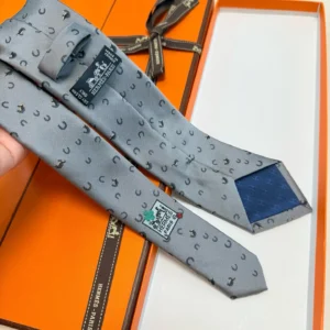 Hermès tie grey silk with black horseshoe pattern and navy blue tip detailing