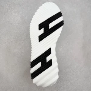 Hermes Men’s Bouncing Sneaker outsole design featuring textured white rubber with black logo accents, showcasing luxury footwear craftsmanship.