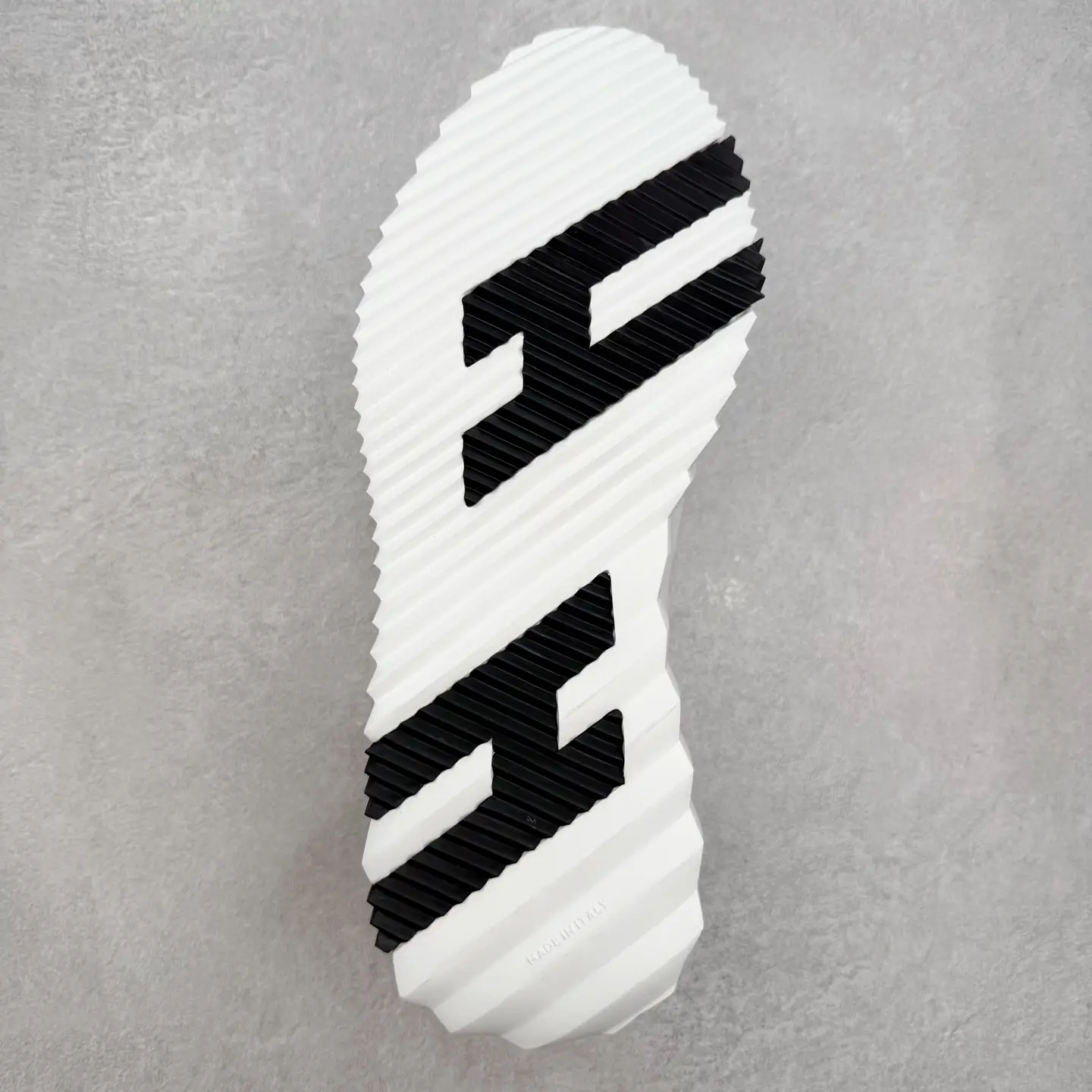 Sole of Hermes Men’s Bouncing Sneaker featuring a textured white and black design, emphasizing luxury craftsmanship and modern style.