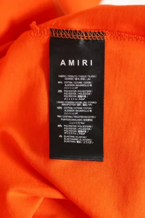 Amiri clothing tag cotton polyester fabric composition on bright orange material