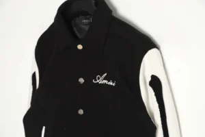 Amiri Wool Blend Bones Appliquéd Varsity Bomber Jacket featuring black and white color scheme, embroidered logo, and button closure, showcasing premium craftsmanship and materials.