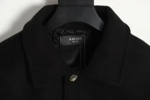 Amiri Wool Blend Bones Appliquéd Varsity Bomber Jacket collar and label detail on hanger, showcasing premium craftsmanship and design.