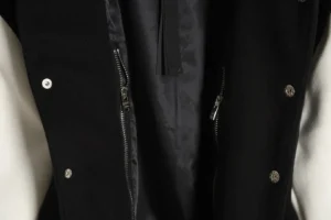 Amiri Wool Blend Bones Appliquéd Varsity Bomber Jacket interior showcasing zipper details and copper ammonia silk lining.