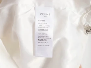 Celine clothing label showing fabric composition, care instructions, and brand details for the Burberry Check And Stripe Wool Blend Jacquard Hoodie.