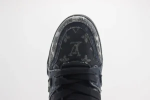 Louis Vuitton Trainer low-cut shoe featuring black leather with signature monogram pattern and detailed toe design, ideal for luxury footwear enthusiasts.