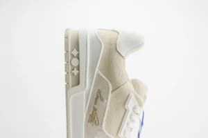 Tyler x Louis Vuitton Trainer low cut casual board shoe in beige and white with signature branding and detailed craftsmanship.