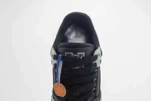 Louis Vuitton Trainer shoes showcasing black and silver design, featuring laces and branding details, ideal for luxury footwear enthusiasts.