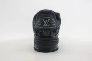 Louis Vuitton Trainer low-cut sneakers showcasing the rear view with distinctive LV logo and textured detailing, emphasizing luxury footwear design.