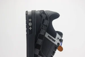 Louis Vuitton Trainer low-cut sneakers in black, featuring signature logo details and a stylish checkered pattern, showcasing luxury footwear design.