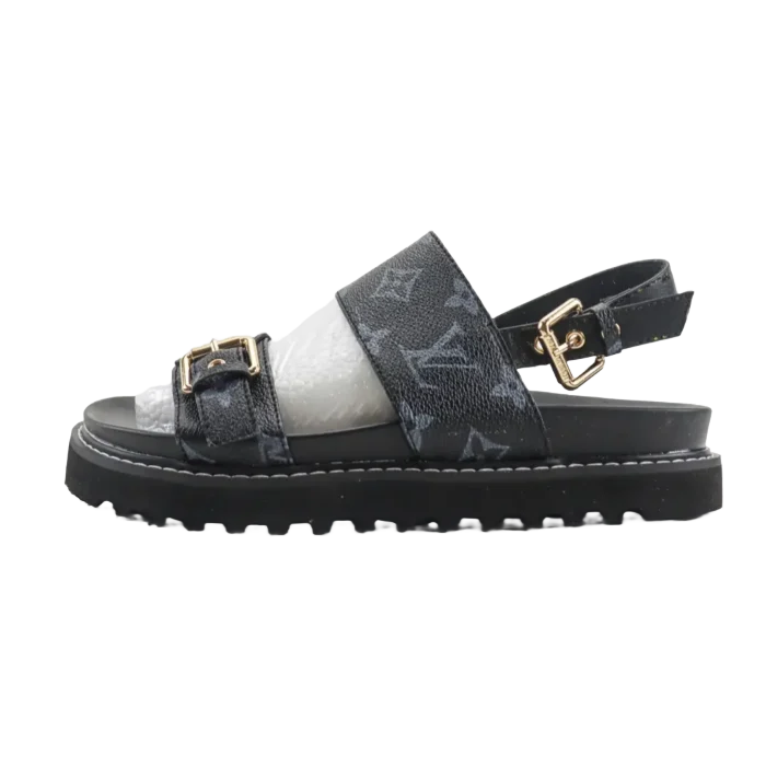 Louis Vuitton black and white sandals with adjustable strap and gold buckle, featured in RepsGoat's e-commerce listing for stylish footwear options.
