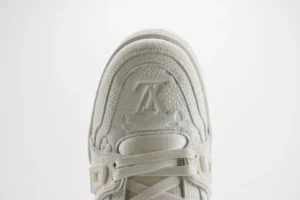 Close-up view of a Louis Vuitton Trainer sneaker showcasing the textured upper, embossed logo, and lacing details, emphasizing luxury craftsmanship and design.