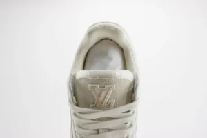 Close-up of a Louis Vuitton Trainer sneaker showcasing the logo and lacing details, emphasizing luxury craftsmanship and design.