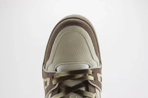 Top view of Tyler x Louis Vuitton Trainer sneaker featuring premium materials and detailed craftsmanship, showcasing a blend of beige and brown colors.