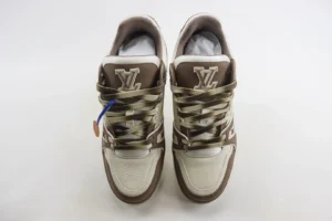 Tyler x Louis Vuitton Trainer sneakers in brown and white with prominent LV logo and intricate lacing design, highlighted as a luxury replica product.