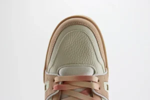 New Balance 550 beige blush pink leather sneakers with gradient laces and textured upper material