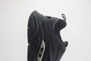 Dior B22 shoes in black and grey, featuring a thick low cut design, mesh upper, and embossed “CD” logo, showcased on a plain background.