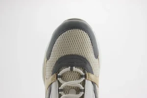 Dior B22 sneaker featuring a thick low cut design, textured mesh upper, and decorative embossed “CD” logo.