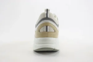 Dior B22 shoes showcasing a thick low-cut design, featuring a beige and white upper with mesh fabric and a rubber sole, emphasizing luxury sneaker aesthetics.