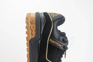 Louis Vuitton Trainer sneaker in black and tan, showcasing premium craftsmanship and logo details, featured on an e-commerce page for luxury replica shoes.