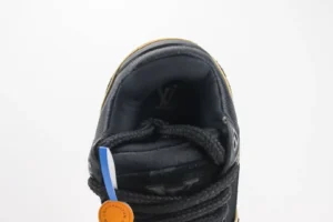 Louis Vuitton Trainer sneaker featuring a black leather upper, visible logo detail, and orange tag, showcased for luxury footwear purchase.