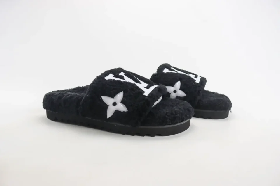 Louis Vuitton LV Slide Mule black shearling slippers with signature white logo and flower embellishment