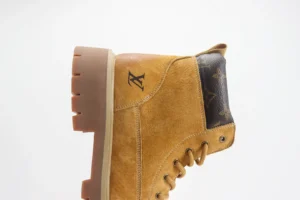 Louis Vuitton casual yellow boots featuring a suede upper, iconic logo, and rugged sole, highlighting luxury footwear design.