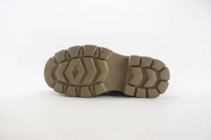 Bottom view of Louis Vuitton boots showcasing the anti-slip rubber foam outsole design, featuring a light bottom and modern tread pattern, relevant to the luxury footwear collection.