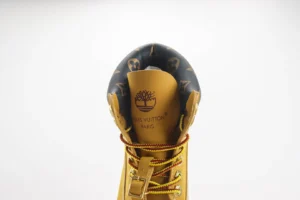 Louis Vuitton Explorer boot brown leather with monogram canvas collar and yellow red laces