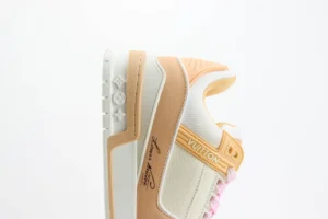 Louis Vuitton Trainer Low Cut Casual sneaker in beige and white, featuring signature branding and unique design elements, showcased for replica luxury footwear purchase.
