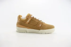 Louis Vuitton Trainer low-cut casual sneaker in tan suede with white sole, showcasing luxury design and craftsmanship.