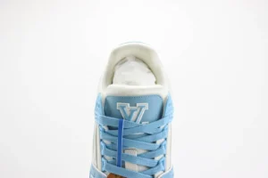 Louis Vuitton Trainer Low Cut Casual sneaker in blue and white, featuring prominent 'V' logo on the tongue and stylish lace design, showcasing luxury footwear aesthetic.