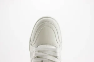 Nike Air Jordan 1 Low triple white leather sneakers with white laces close-up view