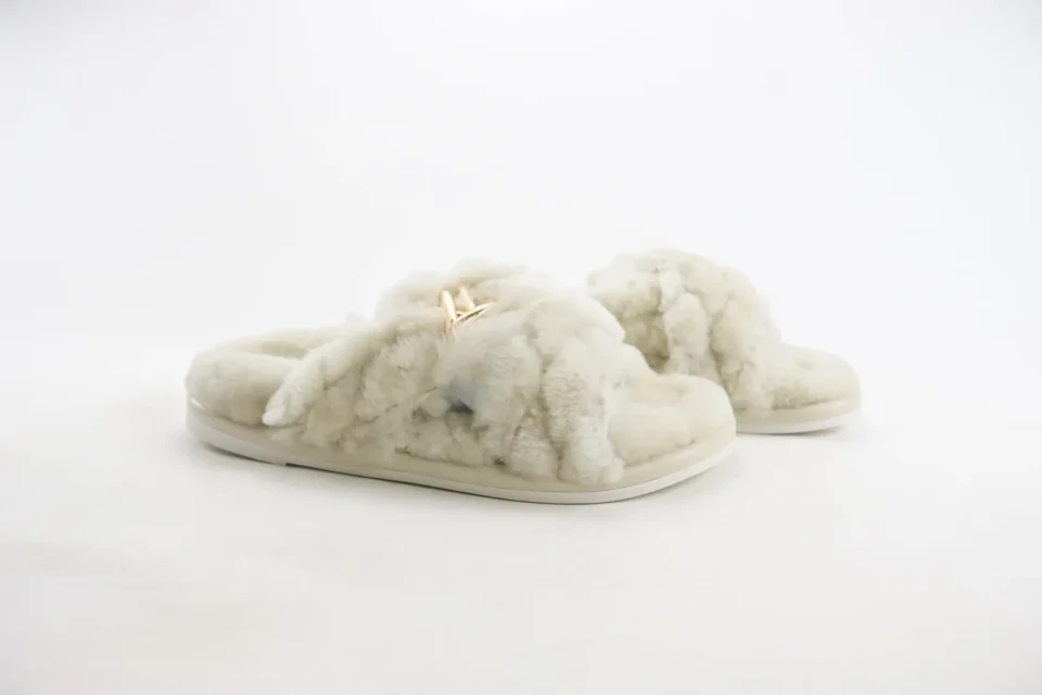 Ugg Fluff Yeah Slide slippers cream shearling plush material with gold logo hardware