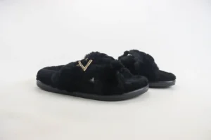 Valentino slippers black faux fur slippers with gold V logo and rubber sole slippers