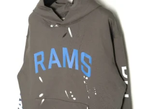 GALLERY DEPT GD Inkjet Hot Stamped Letter Hoodie in brown with blue "RAMS" lettering and artistic ink splashes, showcasing eco-friendly materials and craftsmanship.