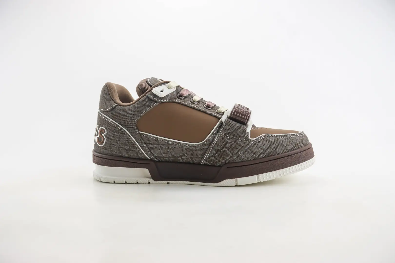Louis Vuitton Trainer limited edition low-cut casual board shoes in brown and gray, featuring a unique pattern and design, displayed against a neutral background.