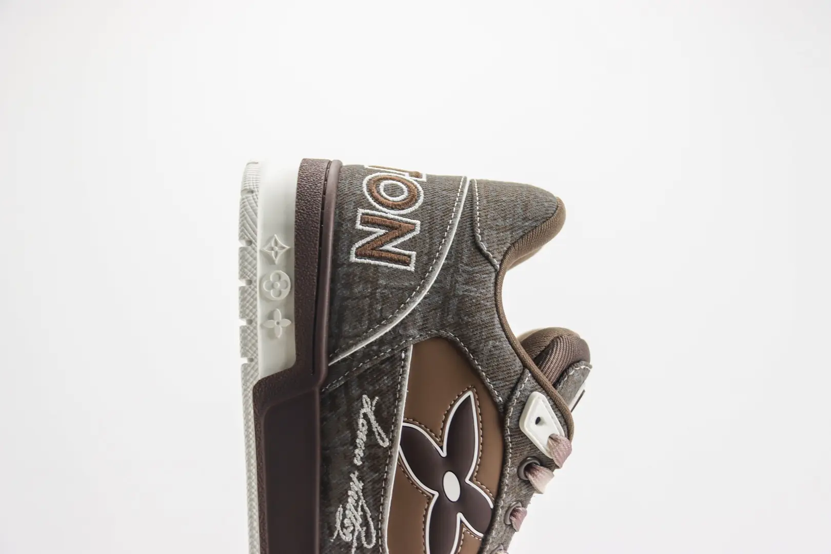 Louis Vuitton Trainer limited edition low-cut casual board shoe featuring a brown and gray design, logo detailing, and stylish lacing.