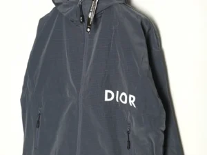 Dior Men's Technical Fabric Hooded Jacket in dark gray with white logo, featuring a zippered front and adjustable hood, showcasing modern streetwear style.