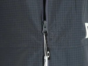 Dior Men's Technical Fabric Hooded Jacket zipper detail with logo and grid pattern, showcasing high-quality materials and design features.