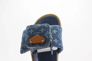 Leather round toe flip flops featuring Takashi Murakami x Louis Vuitton design, showcasing denim upper with iconic logo pattern and brown leather accents.