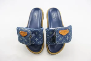 Leather round toe flip flops from the Takashi Murakami x Louis Vuitton collection, featuring a denim upper with signature monogram pattern and a decorative buckle, suitable for indoor and outdoor wear.