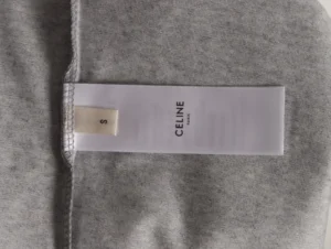 Celine clothing label size S on gray fabric material background
