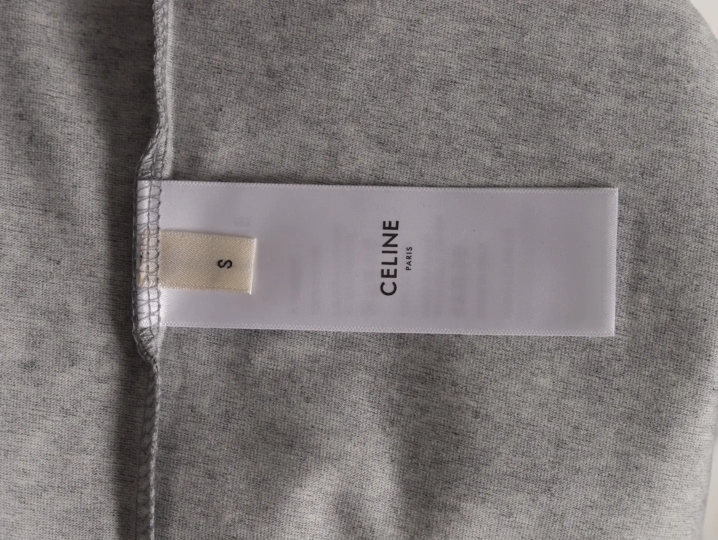Celine clothing label size S on gray fabric material background