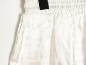 Fendi FF Dark Pattern Jacquard Beach Shorts featuring a white design with elastic waistband and tag, showcasing stylish luxury for summer wear.