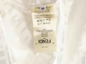 Fendi label on beach shorts featuring care instructions and size information, highlighting the brand's designer quality and authenticity.