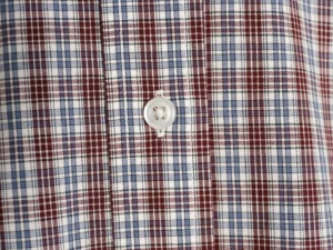 MIU MIU Brown Blue Fine Grid Long Sleeve Shirt close-up, featuring a button detail and a cotton jacquard fabric pattern in brown and blue grid design.
