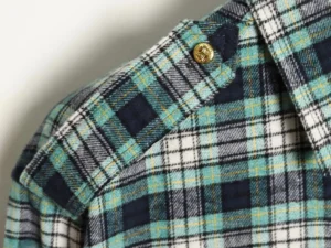 Celine green plaid flannel shirt featuring shoulder patches and gold button detail.